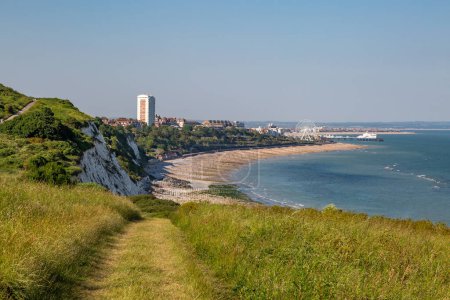 Looking along a grass pathway with the town of Eastbourne beyond