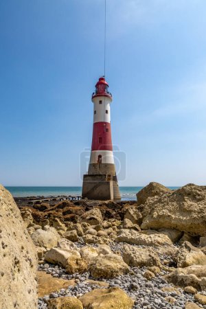 Beachy Head Lighthouse and the rocky beach at low tide, on a sunny summer's day