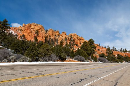 A view of a road running by Red Canyon in Utah, on a sunny winter's day