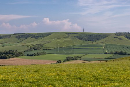 A view towards Firle Beacon in the South Downs, from countryside near Glynde, on a sunny spring day