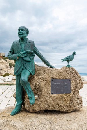 Foto de Sciacca, Italia - 9 de mayo de 2023: Estatua del poeta Vincenzo Licata, conocido como poeta del mar, creada por el artista Filippo Prestia en el puerto de Sciacca, pueblo pesquero en Sicilia, Italia - Imagen libre de derechos