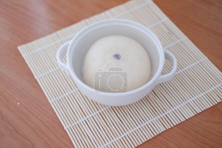 Photo for Baozi or Bakpao is a type of yeast-leavened filled bun in various Chinese cuisines. There are many variations in fillings (meat, chocolate) and preparations, though the buns are most often steamed. - Royalty Free Image