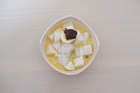 Rice cake in a bowl on wooden table, top view.