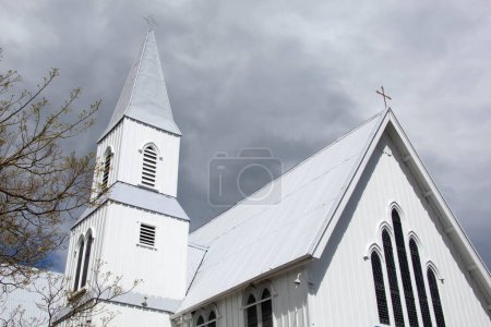 Photo for The dark heavy clouds over the wooden Presbyterian Church in Akaroa resort town (New Zealand). - Royalty Free Image
