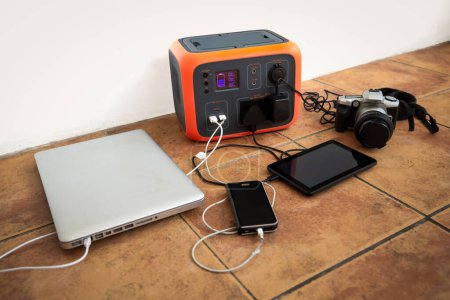 Portable power station solar electricity generator - laptop, phone, tablet and digital camera electronic devices charging. Wireless charging battery backup, power outage emergencies outdoors, camping