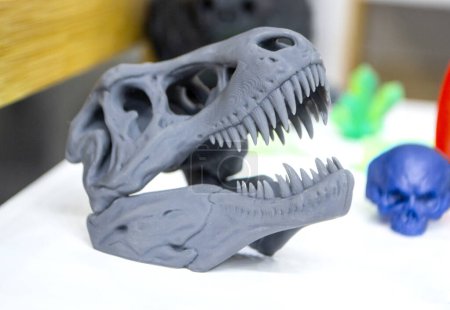 Téléchargez les photos : Modèle crâne de dinosaure imprimé sur imprimante 3D. Photopolymère d'objet imprimé sur imprimante 3D stéréolithographique. Technologie de photopolymérisation liquide sous lumière UV. Nouvelle technologie d'impression 3D additive - en image libre de droit