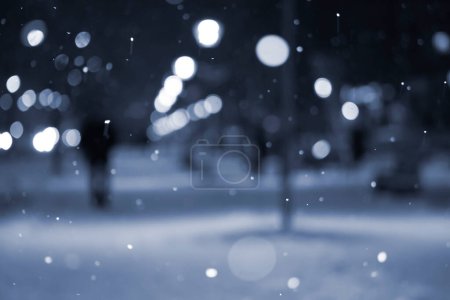 Photo for Blurred background. City view, lights, falling snow, night, street, bokeh spots of headlights. Diffuse Urban backdrop winter scenery of street in city at night. Lantern light, snowfall Blue color - Royalty Free Image
