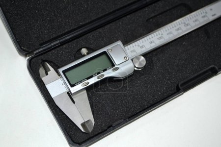 Photo for Digital electronic vernier caliper in plastic black box isolated on white background closeup. Engineering industrial measuring equipment. Universal high-precision measuring device instrument. - Royalty Free Image