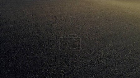 Photo for Landscape of plowed up land on agricultural field on sunny autumn day. Flying over plowed earth with black soil. Black soil. Agrarian background. Ground earth dirt priming. Aerial drone view. - Royalty Free Image