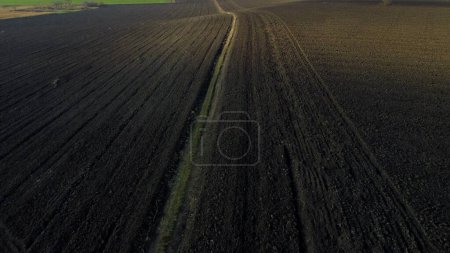 Photo for Landscape of plowed up land on agricultural field on sunny autumn day. Flying over plowed earth with black soil. Ground earth dirt priming. Agrarian background. Black soil. Aerial drone view. - Royalty Free Image