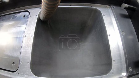 Photo for Pouring metal powder into working surface of 3D printer for metal. Selective laser melting technology. SLM. Flowing Metal Powder inside 3d printer for metal. Filling working chamber with powder. - Royalty Free Image