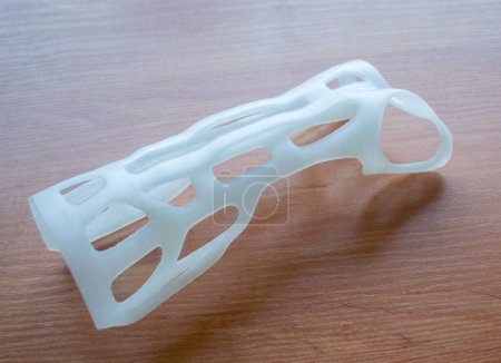Hand arm splint corset prosthesis langet printed on a 3D printer from molten plastic. Medical orthosis, fixator, plastic overlay created on 3D printer. New modern medical 3D printing technologies