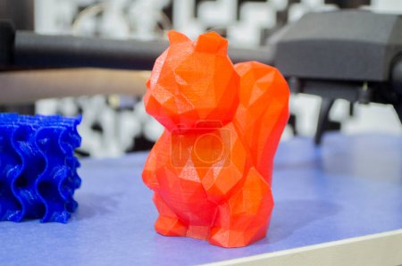 Art object model of squirrel printed on 3D printer. Toy created by 3D printing from molten plastic. Example of creating prototype by 3D printer. Concept 3D printing. Printing innovation technology