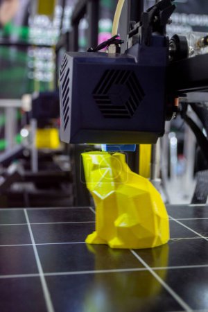 3D printer prints an object. The process of printing model on 3D printer. Model printed on 3D printer from molten plastic. 3D printing technologies. Additive progressive new modern printing technology
