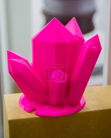 Abstract art object printed on 3D printer. Colored pink creative model printed 3D printer from molten ABS PLA plastic filament. Object printed FDM printer. Additive progressive new modern technology