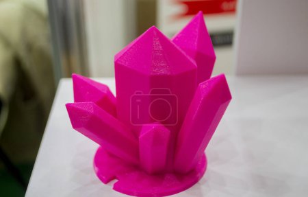 Abstract art object printed on 3D printer. Colored pink creative model printed 3D printer from molten ABS PLA plastic filament. Object printed FDM printer. Additive progressive new modern technology