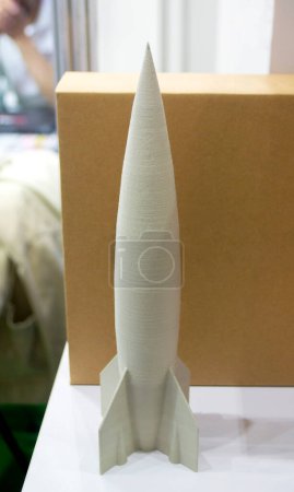 Abstract art object printed on 3D printer. Colored beige creative model rocket printed on 3D printer from molten ABS, PLA plastic filament. Object printed FDM printer. Additive new modern technology
