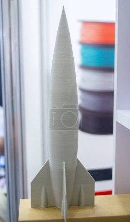 Abstract art object printed on 3D printer. Colored beige creative model rocket printed on 3D printer from molten ABS, PLA plastic filament. Object printed FDM printer. Additive new modern technology