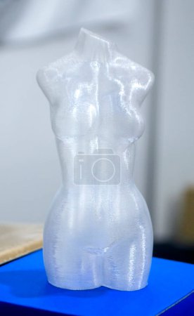 Woman body printed on 3D printer. Woman figure shaped object created 3D printer from plastic. Detailed prototype woman body printed on 3D printer close-up. New modern additive 3D printing technologies