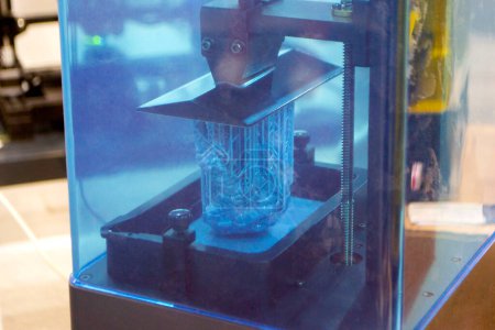 Proceso de impresión 3D SLA. Impresión de procesos en impresora 3D mediante tecnología de impresión SLA. Objeto impreso en 3D de polimerización de resina. Objeto creado en impresora 3D a partir de resina endurecida. Tecnología de impresión