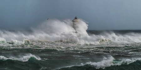 The lighthouse of the mangarche of calasetta in southern sardinia submerged by the waves of a stormy sea