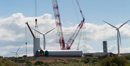 Foto de Pala de viento - una grúa grande trabaja en la construcción de una pala de viento - Imagen libre de derechos
