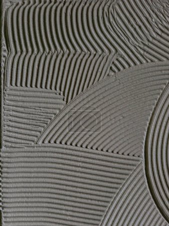 Textura adhesivo cementoso aplicado al suelo listo para recibir la baldosa cerámica