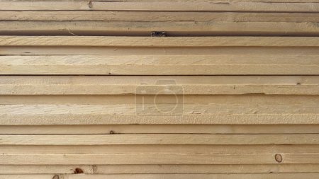 wooden poles that create the wall of a house in the mountains
