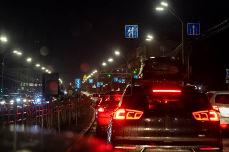 Photo for Traffic jam on the road in the late evening during a rainstorm. Bad weather - Royalty Free Image