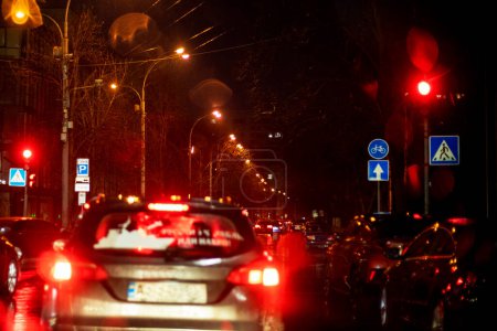 Photo for Traffic jam on the road late in the evening during a downpour in the capital, Kyiv. Bad weather. War in Ukraine - Royalty Free Image