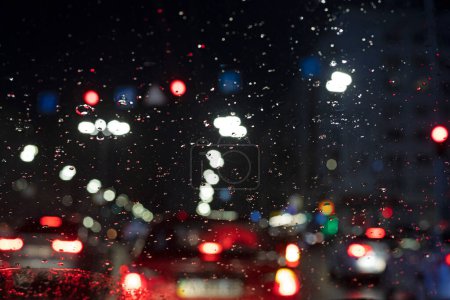 Photo for Abstract blurred background during rain in a traffic jam in a big city. Bad weather - Royalty Free Image