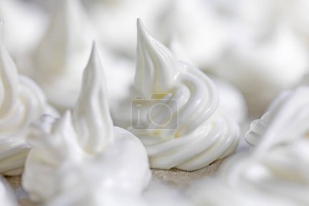 Photo for Classic white meringue lined with foil before baking. Festive mood - Royalty Free Image