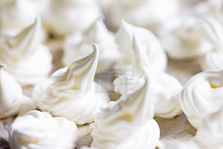 Photo for Close-up of classic white meringue laid out on foil before baking. Festive mood - Royalty Free Image