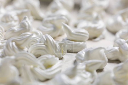 Photo for Close-up of classic white meringue laid out on foil before baking. Festive mood - Royalty Free Image