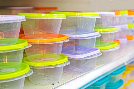 transparent plastic containers with colorful lids on the store counter, horizontal