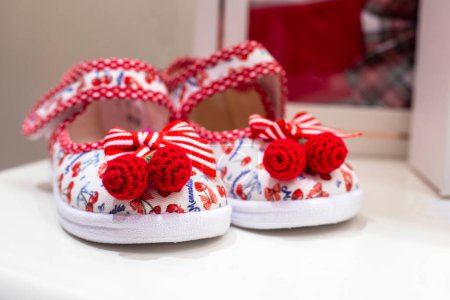Photo for Cute sandals for a child with red knitted buboes. Summer is coming - Royalty Free Image