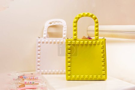Photo for Cute trendy white and yellow handbags on a light background - Royalty Free Image