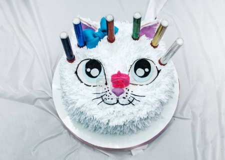 Photo for Beautiful white cat cake with candles at a children's birthday party top view. kids party - Royalty Free Image