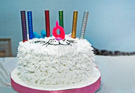 Photo for Beautiful white cat cake with candles for a children's birthday with the number 9. children's party - Royalty Free Image