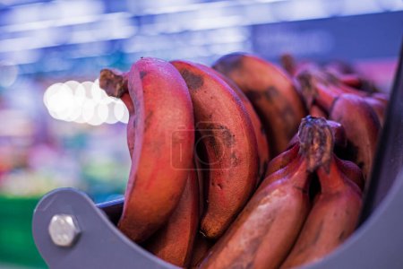 Photo for Bunches of brown bananas on the counter in a supermarket - Royalty Free Image