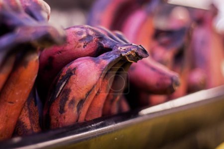 Photo for Bunches of brown bananas on the counter in a supermarket - Royalty Free Image