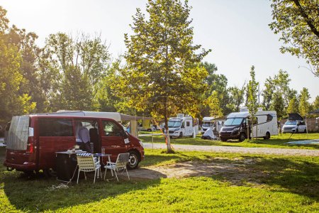 Photo for Camping with motorhomes and cars and tents in the early morning. travel and vacation by car - Royalty Free Image