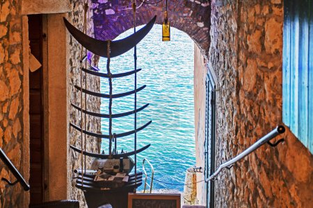 Photo for Arch with access to the sea by a boat in Rovinj in Croatia - Royalty Free Image