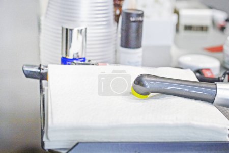 Dental photopolymer lamp for fixing fillings during dental treatment lies on napkins
