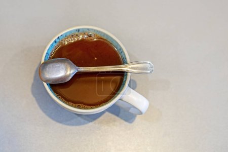 cup with hot natural chocolate on a gray table, top view. mockup