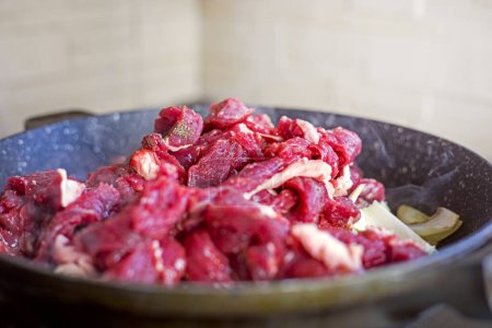 Photo for Raw fresh meat cut into pieces in a frying pan. Cook at home - Royalty Free Image