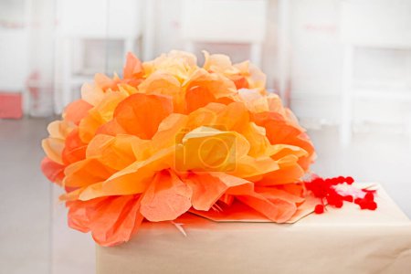 artificial orange flower made of corrugated paper. Gift wrap