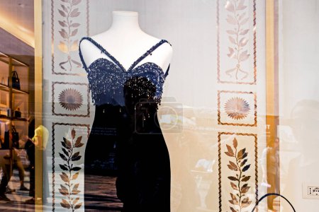 stylisches schwarzes langes Kleid mit schwarzer Handtasche auf einer Schaufensterpuppe