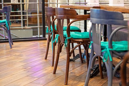 wooden chairs with a table in a modern cafe interior