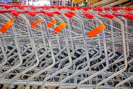 close-up of iron shopping carts leaning against each other in a supermarket